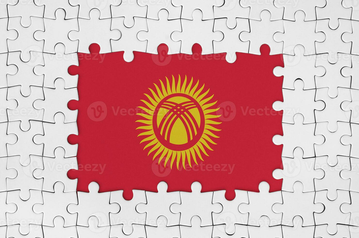 Kyrgyzstan flag in frame of white puzzle pieces with missing central part photo