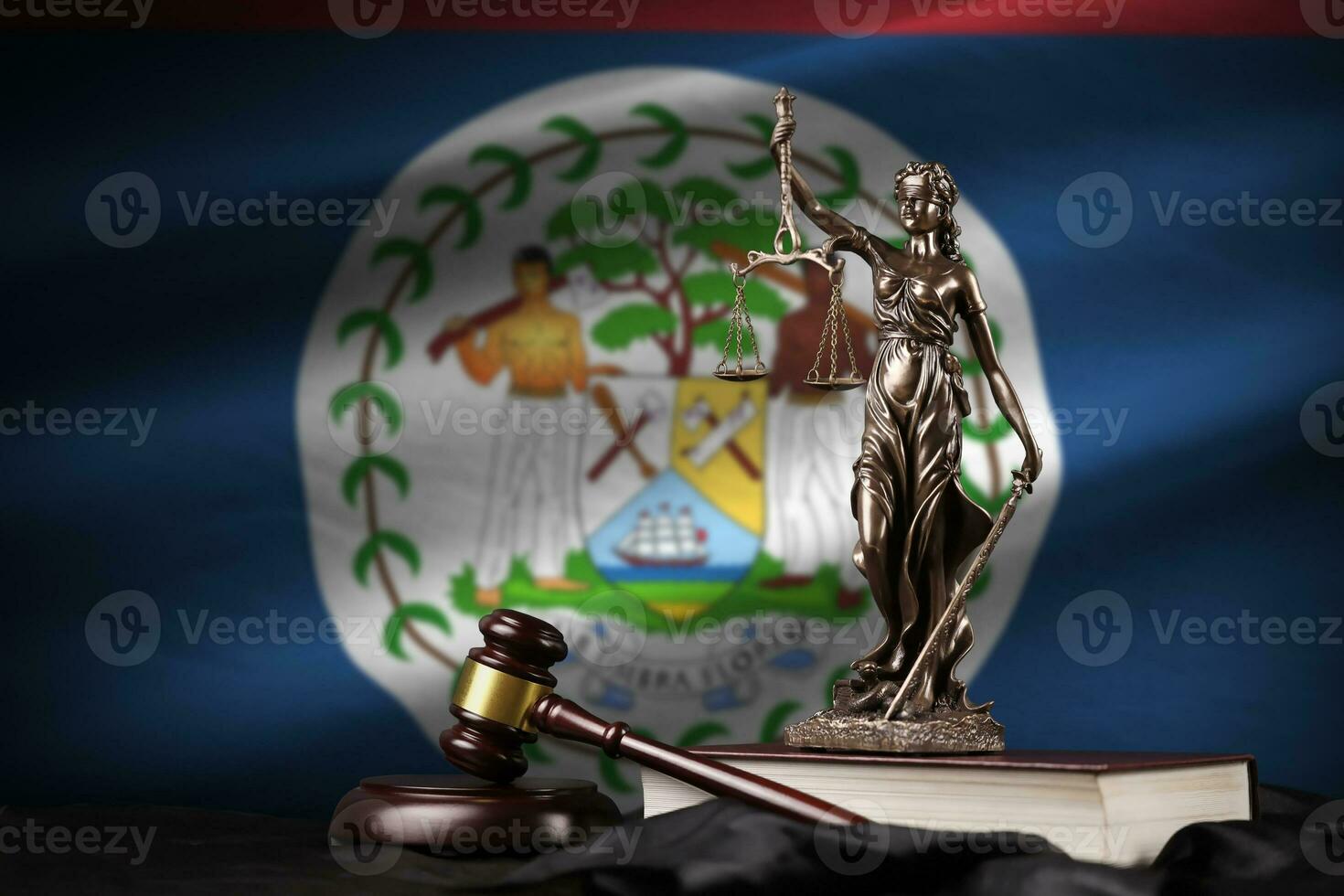 Belize flag with statue of lady justice, constitution and judge hammer on black drapery. Concept of judgement and guilt photo