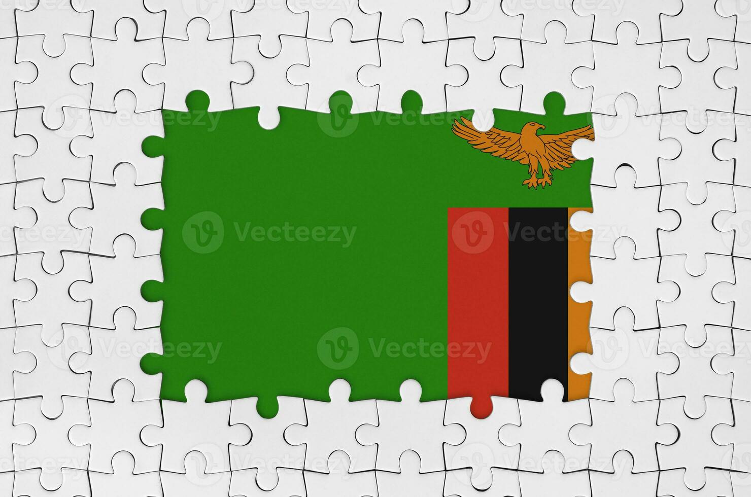 Zambia flag in frame of white puzzle pieces with missing central part photo
