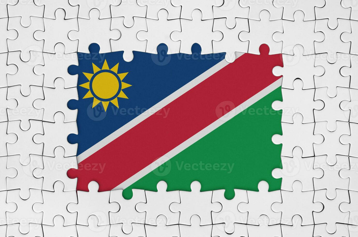 Namibia flag in frame of white puzzle pieces with missing central part photo