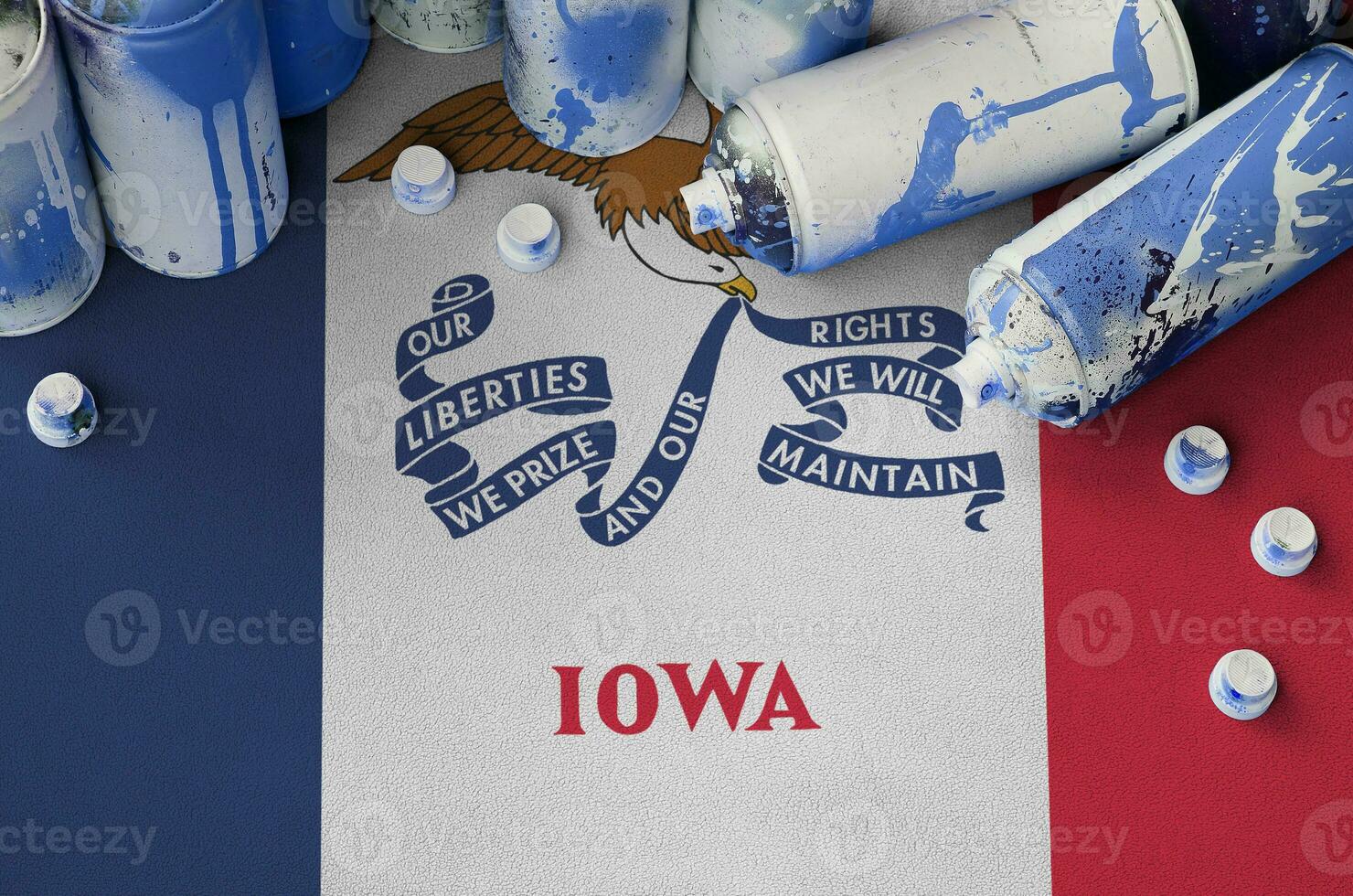 Iowa US state flag and few used aerosol spray cans for graffiti painting. Street art culture concept photo