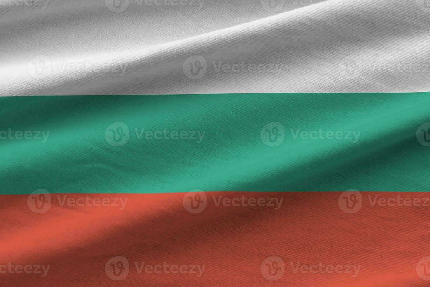 Bulgaria flag with big folds waving close up under the studio light indoors. The official symbols and colors in banner photo