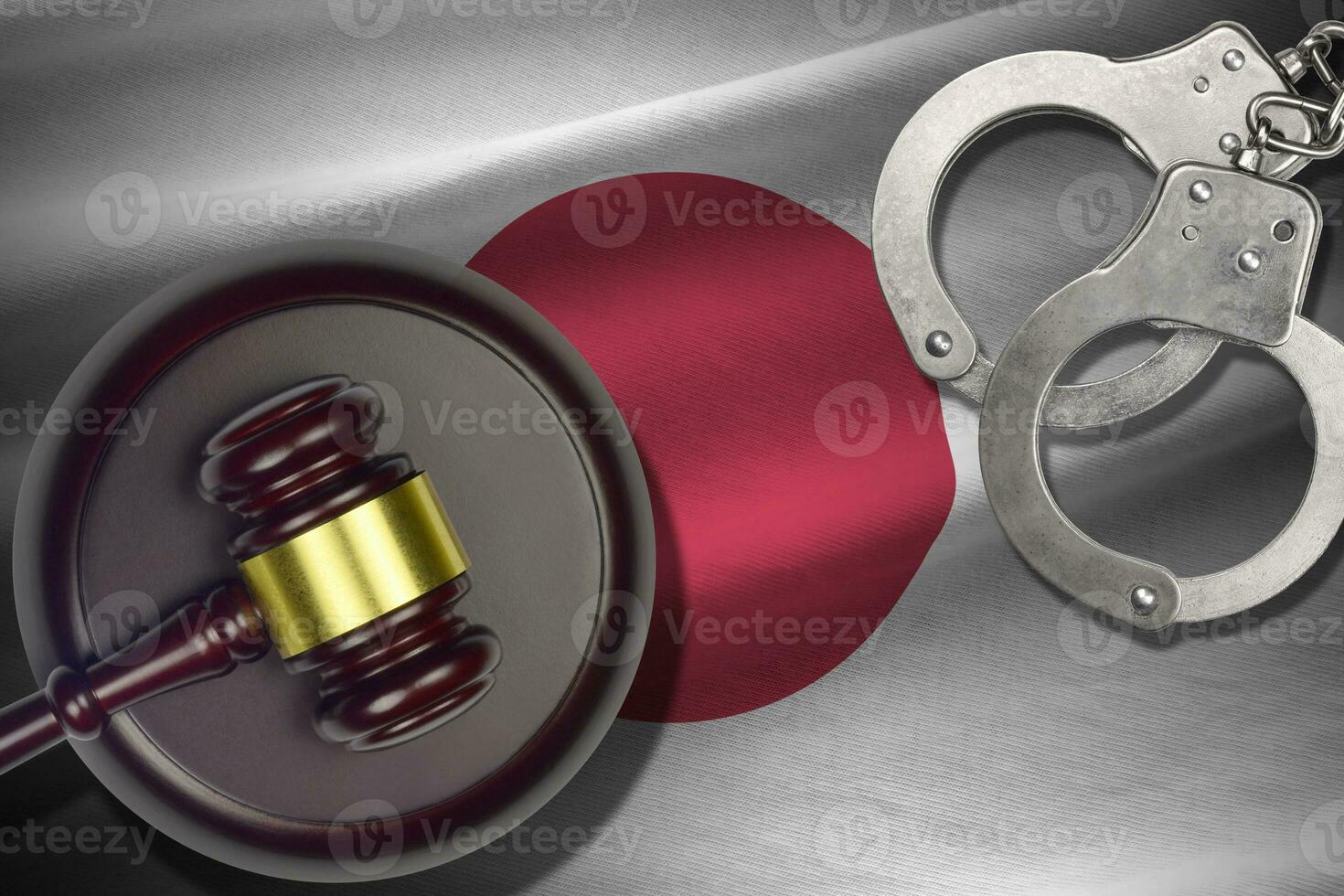Japan flag with judge mallet and handcuffs in dark room. Concept of criminal and punishment, background for judgement topics photo