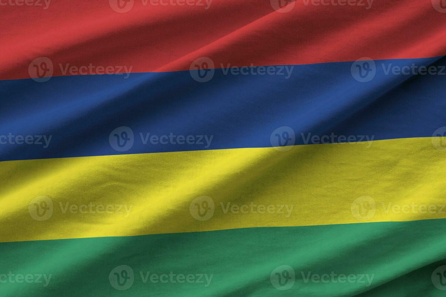 Mauritius flag with big folds waving close up under the studio light indoors. The official symbols and colors in banner photo