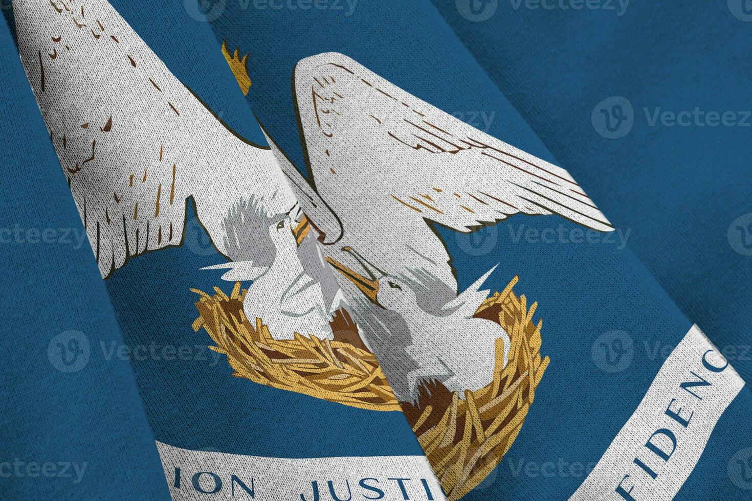 Louisiana US state flag with big folds waving close up under the studio light indoors. The official symbols and colors in banner photo