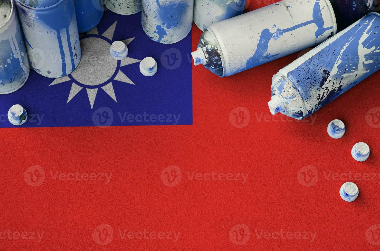Taiwan flag and few used aerosol spray cans for graffiti painting. Street art culture concept photo