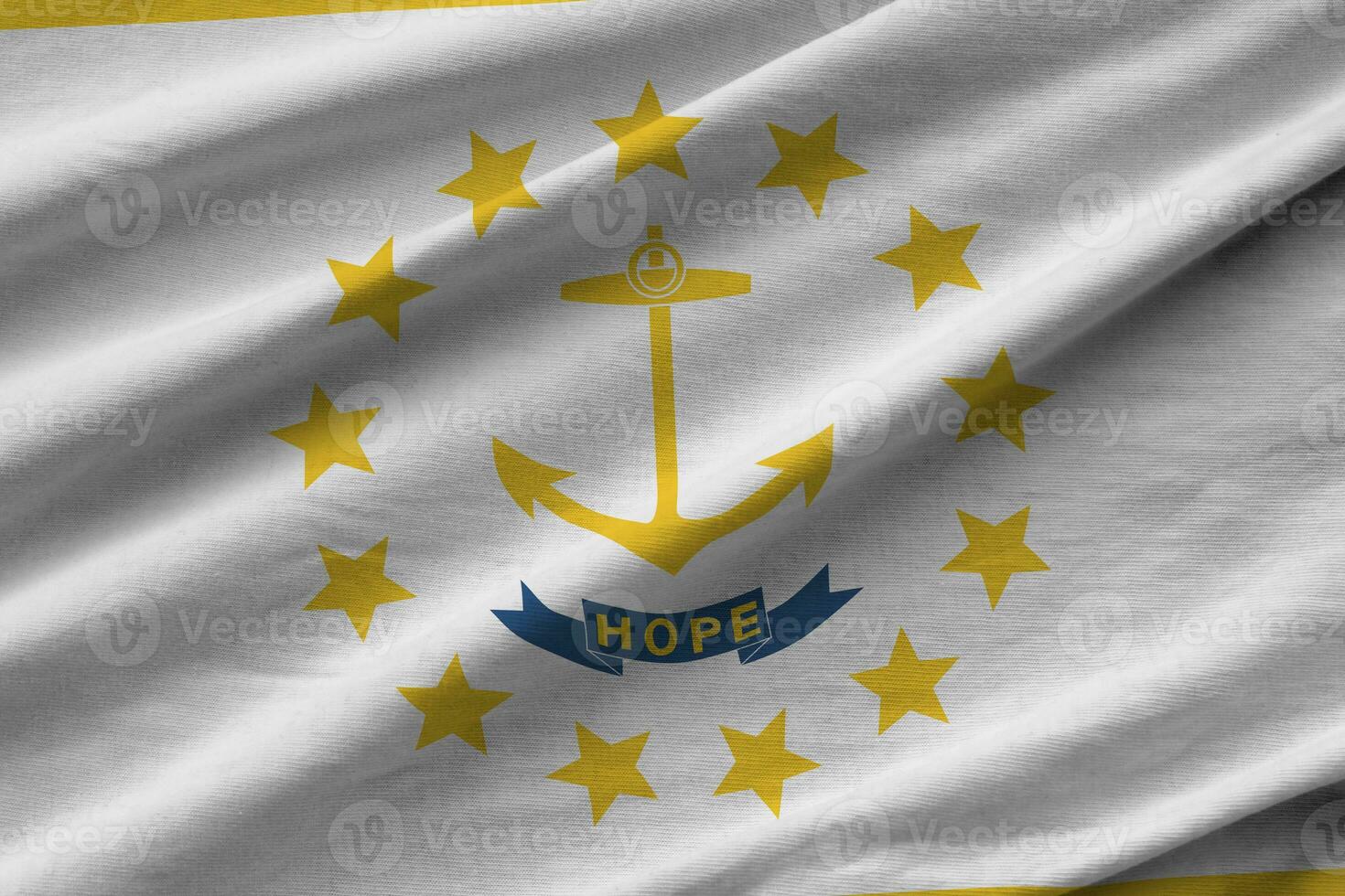 Rhode Island US state flag with big folds waving close up under the studio light indoors. The official symbols and colors in banner photo