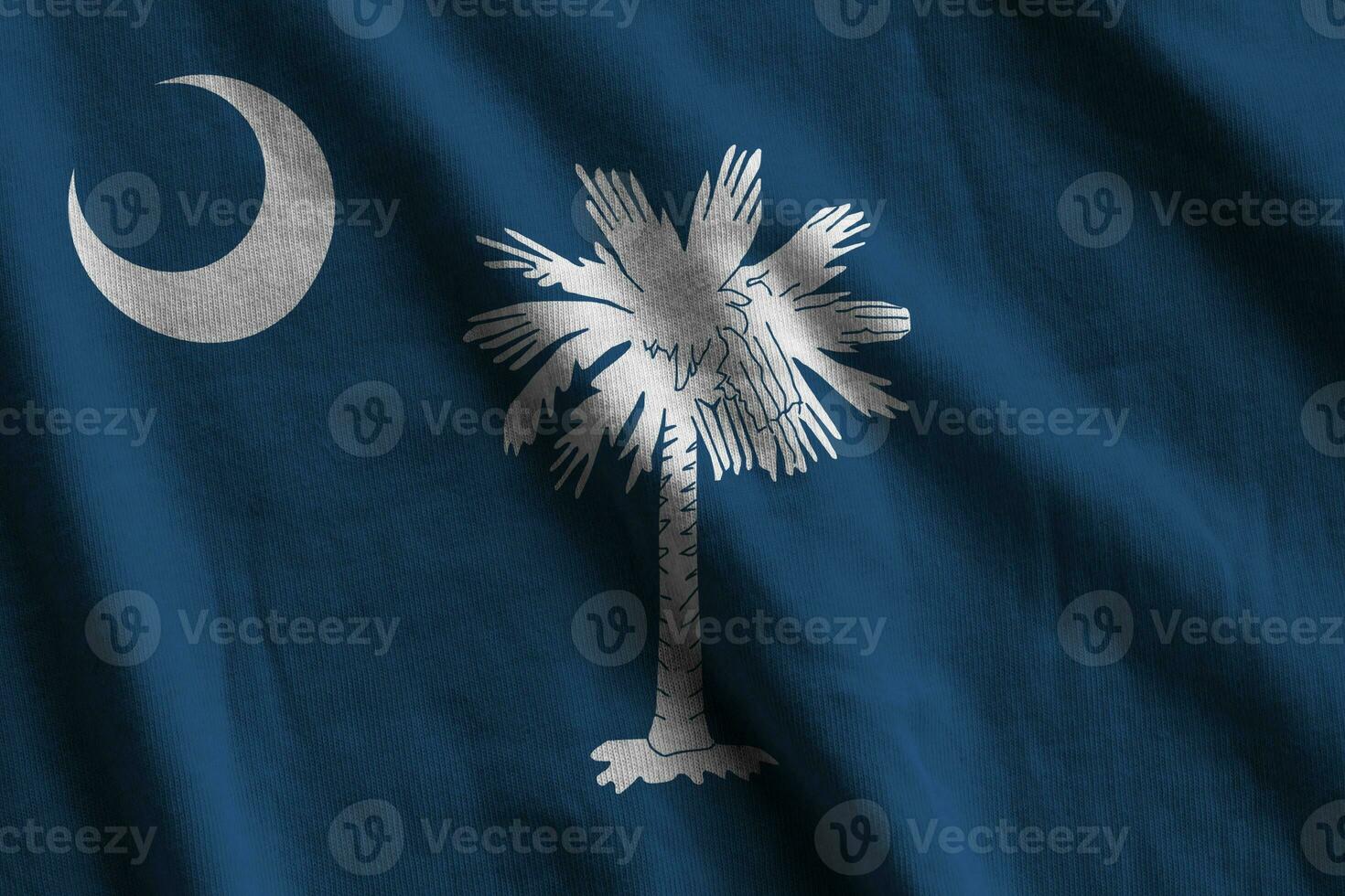 South Carolina US state flag with big folds waving close up under the studio light indoors. The official symbols and colors in banner photo