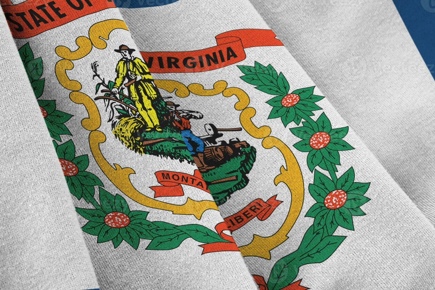 West Virginia US state flag with big folds waving close up under the studio light indoors. The official symbols and colors in banner photo