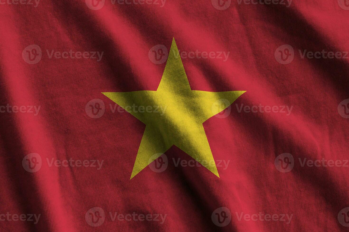 Vietnam flag with big folds waving close up under the studio light indoors. The official symbols and colors in banner photo