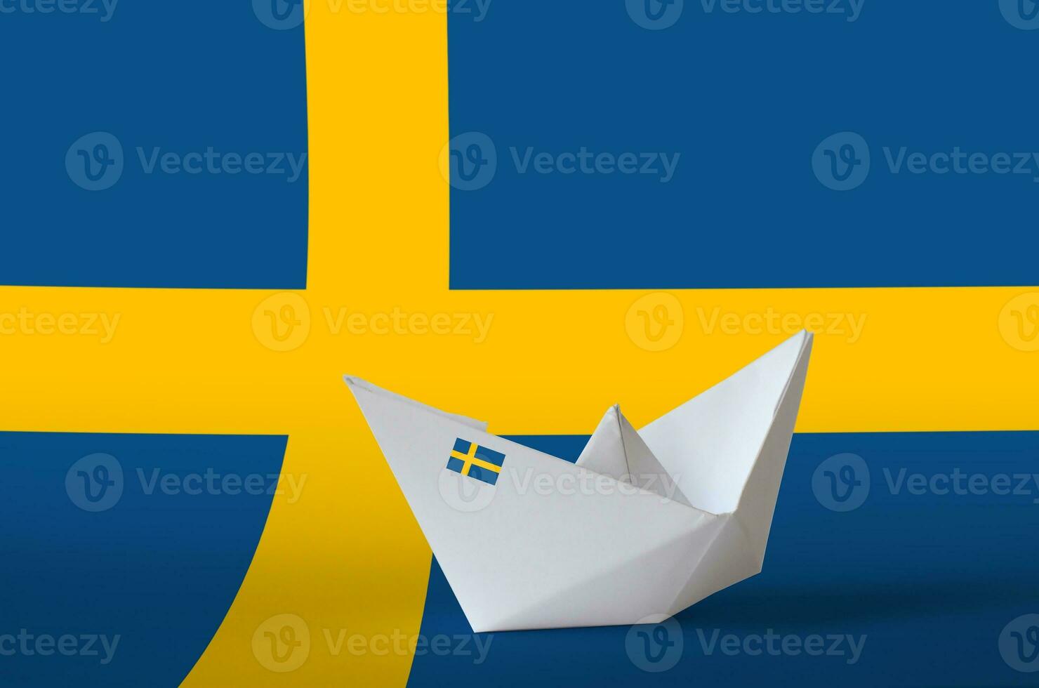 Sweden flag depicted on paper origami ship closeup. Handmade arts concept photo