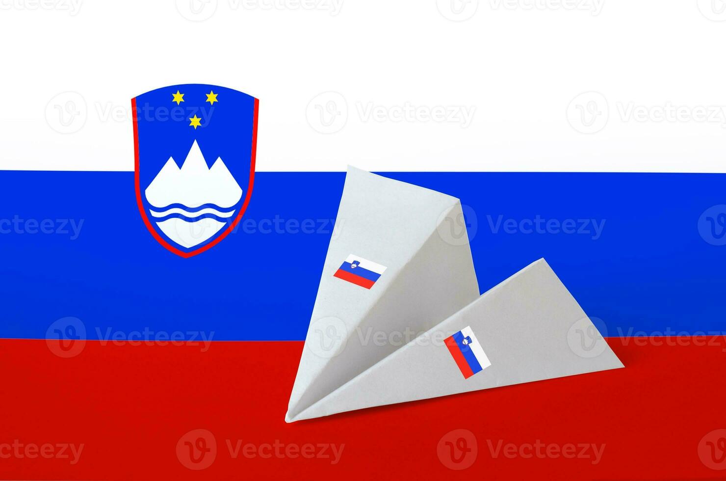 Slovenia flag depicted on paper origami airplane. Handmade arts concept photo