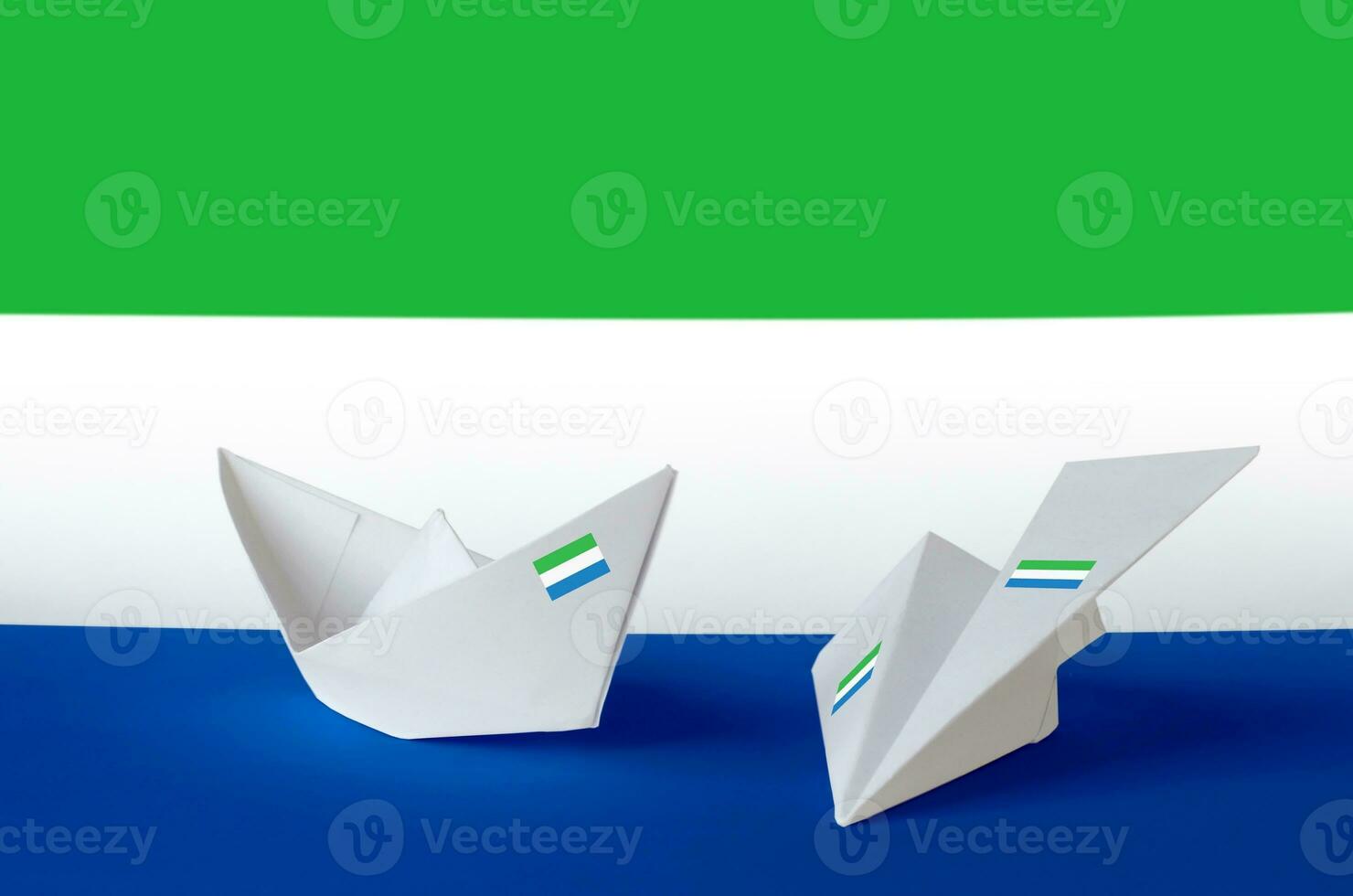 Sierra Leone flag depicted on paper origami airplane and boat. Handmade arts concept photo