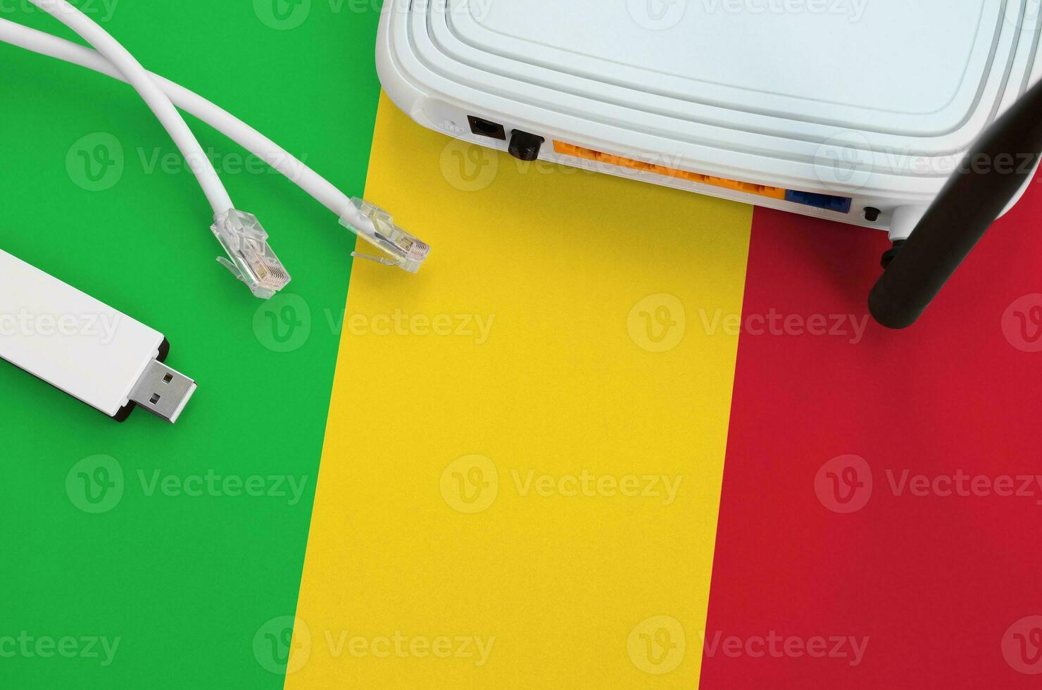 Mali flag depicted on table with internet rj45 cable, wireless usb wifi adapter and router. Internet connection concept photo