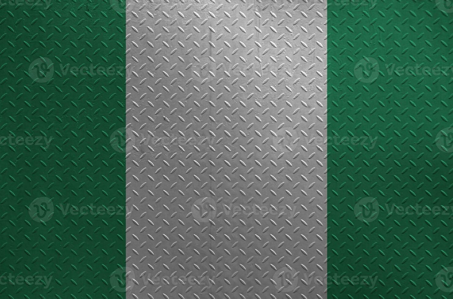 Nigeria flag depicted in paint colors on old brushed metal plate or wall closeup. Textured banner on rough background photo