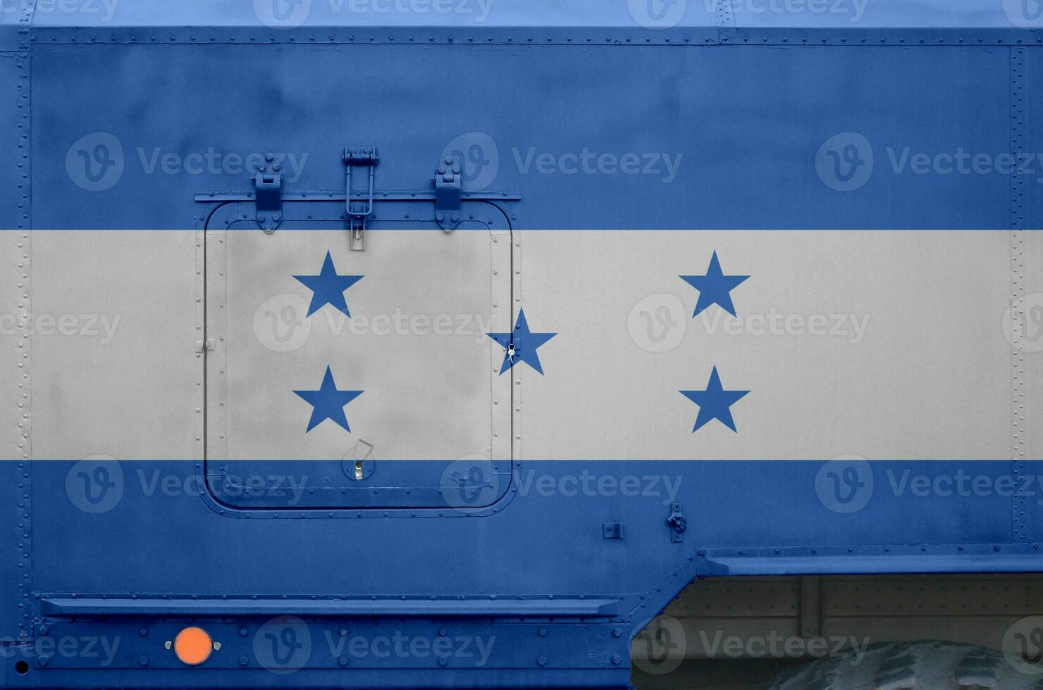 Honduras flag depicted on side part of military armored truck closeup. Army forces conceptual background photo