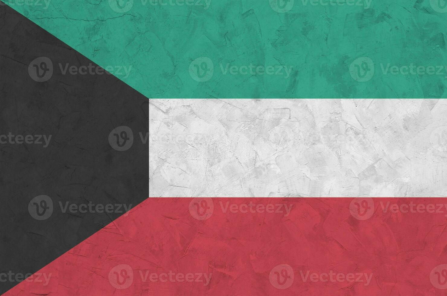Kuwait flag depicted in bright paint colors on old relief plastering wall. Textured banner on rough background photo