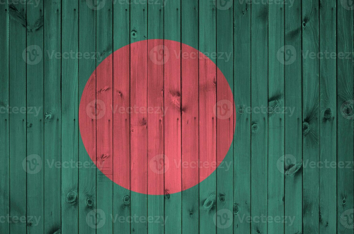 Bangladesh flag depicted in bright paint colors on old wooden wall. Textured banner on rough background photo