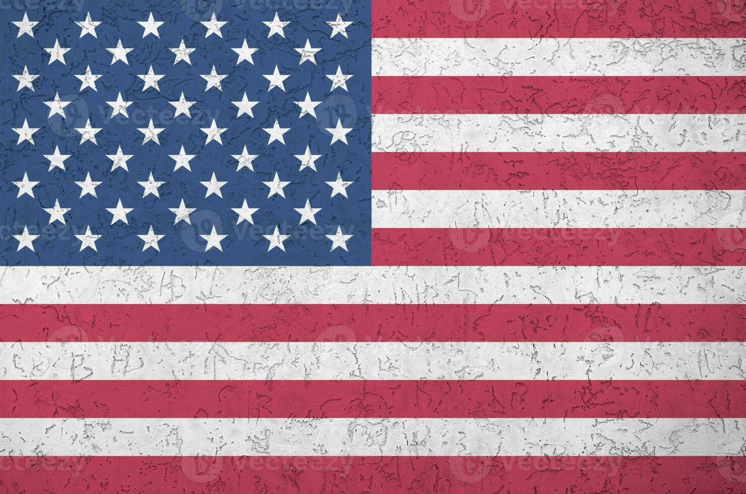 United States of America flag depicted in bright paint colors on old relief plastering wall. Textured banner on rough background photo