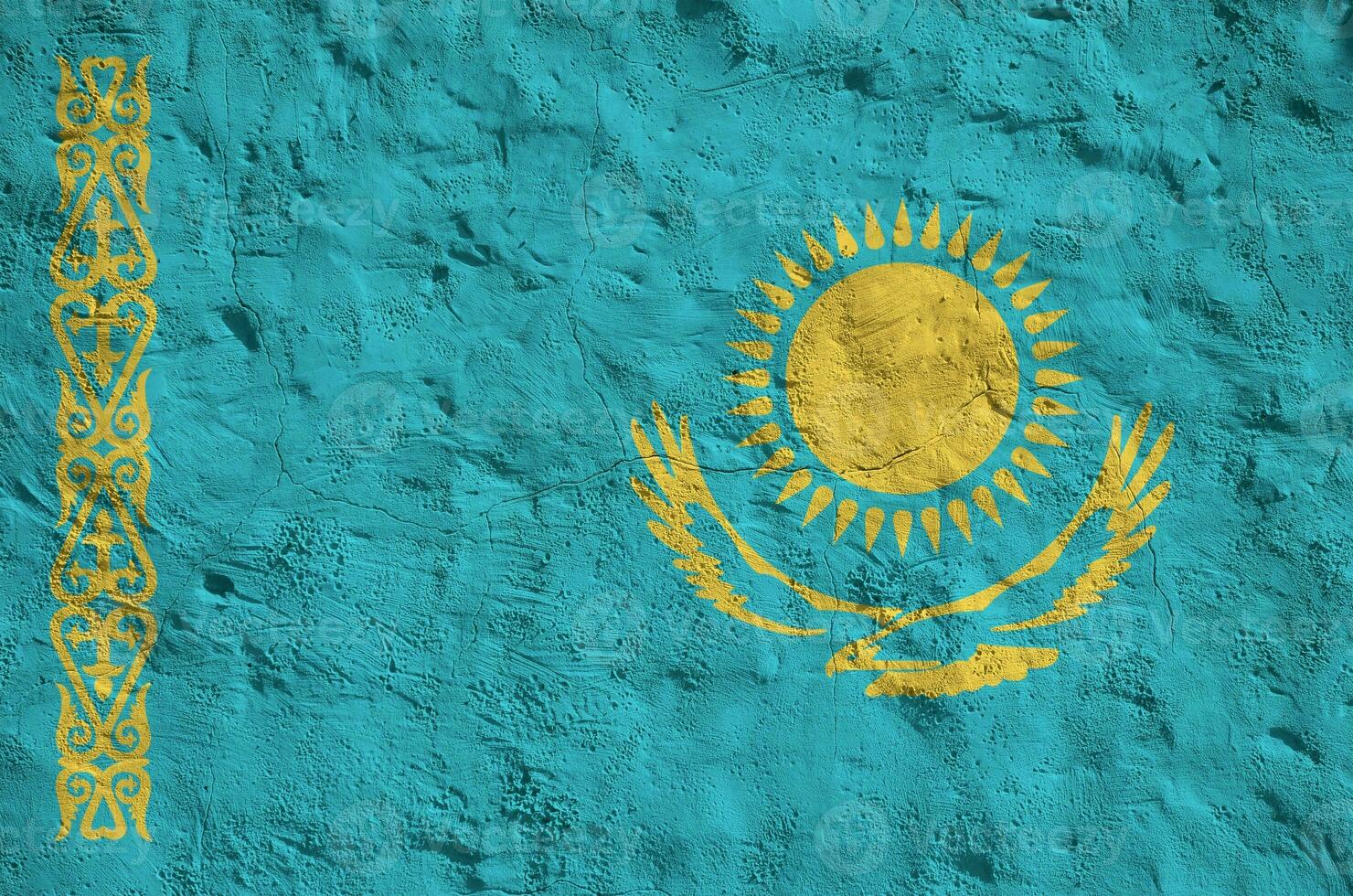 Kazakhstan flag depicted in bright paint colors on old relief plastering wall. Textured banner on rough background photo