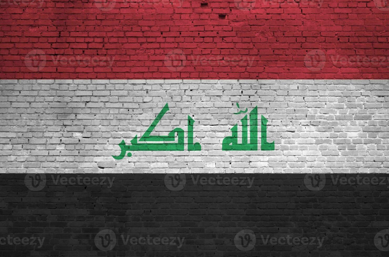 Iraq flag depicted in paint colors on old brick wall. Textured banner on big brick wall masonry background photo