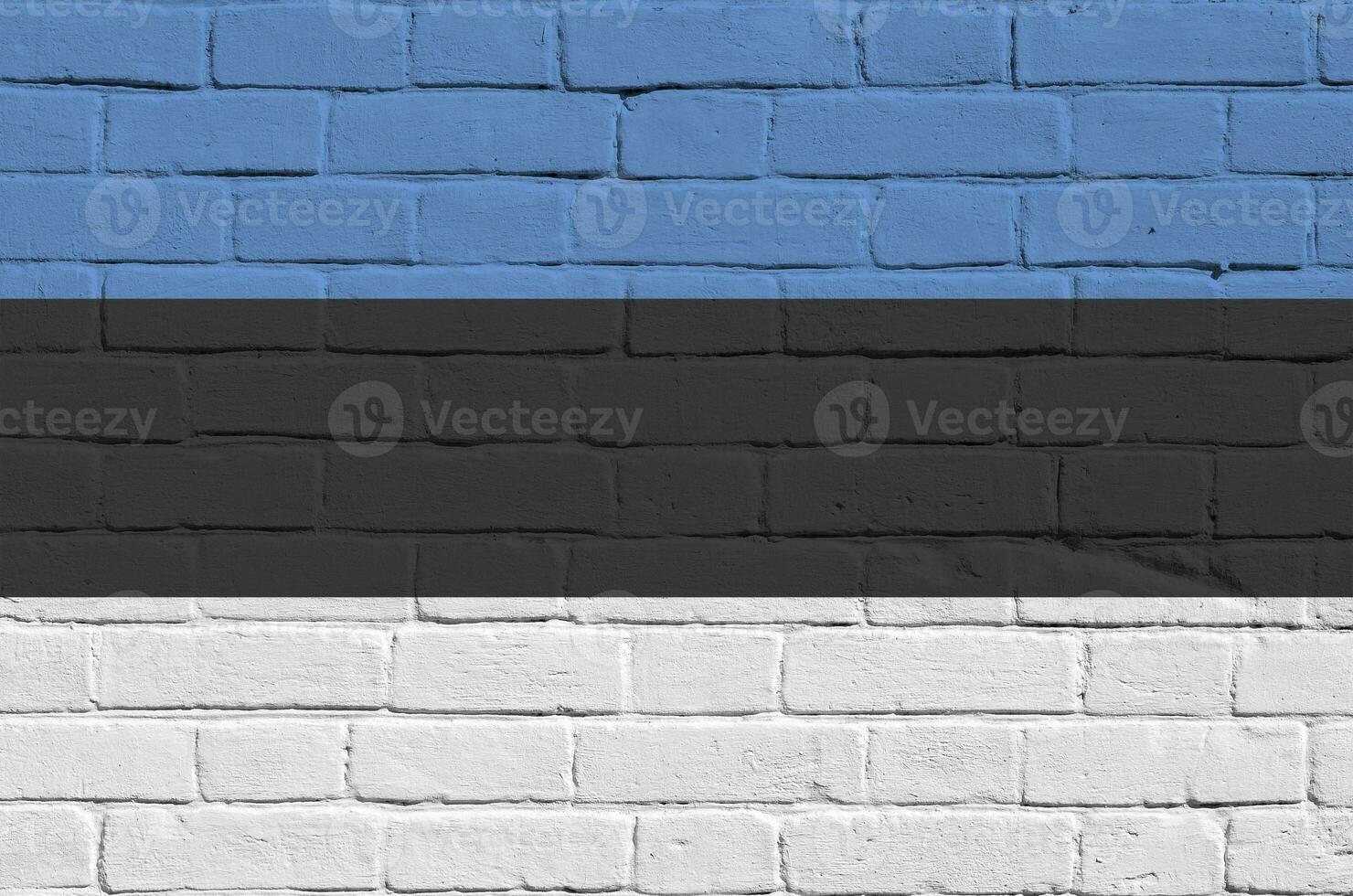 Estonia flag depicted in paint colors on old brick wall. Textured banner on big brick wall masonry background photo