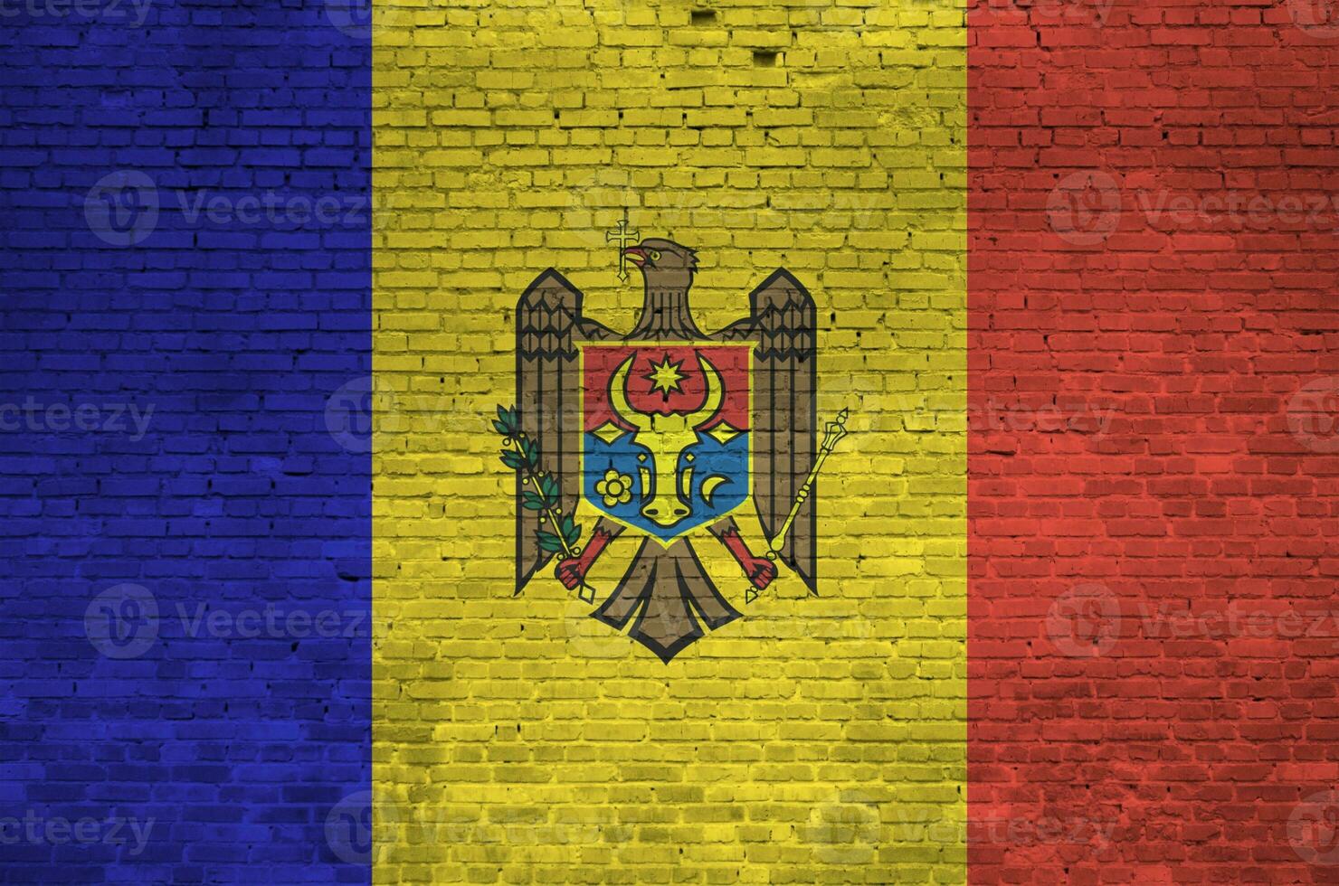 Moldova flag depicted in paint colors on old brick wall. Textured banner on big brick wall masonry background photo