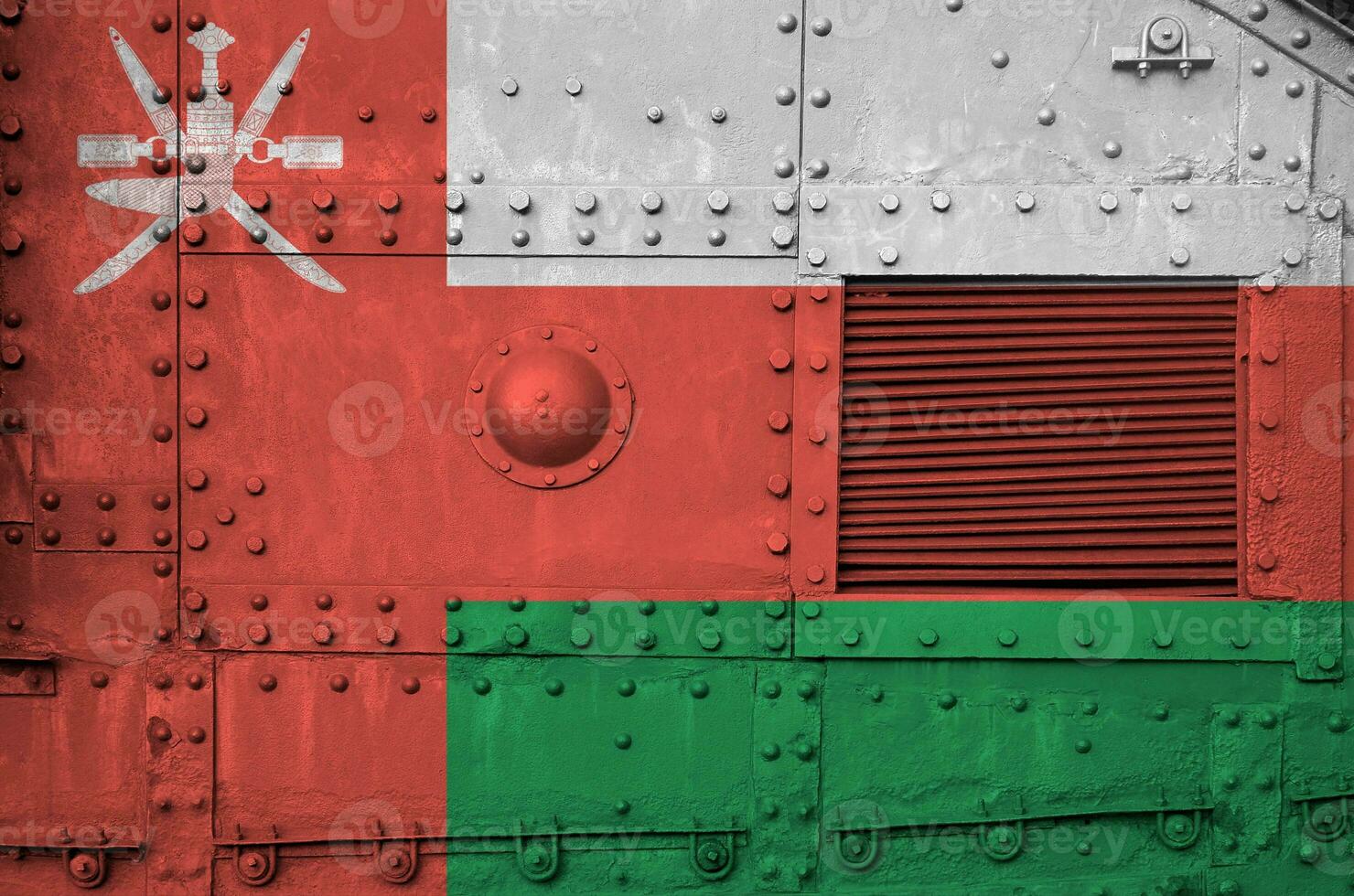 Oman flag depicted on side part of military armored tank closeup. Army forces conceptual background photo