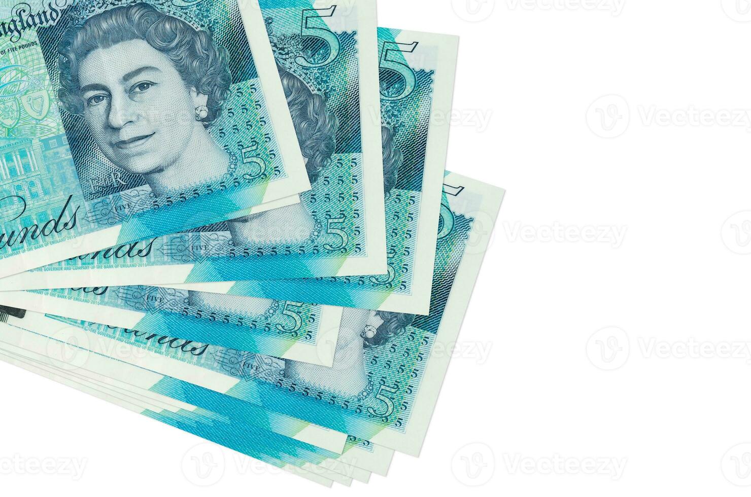 5 British pounds bills lies in small bunch or pack isolated on white. Mockup with copy space. Business and currency exchange photo