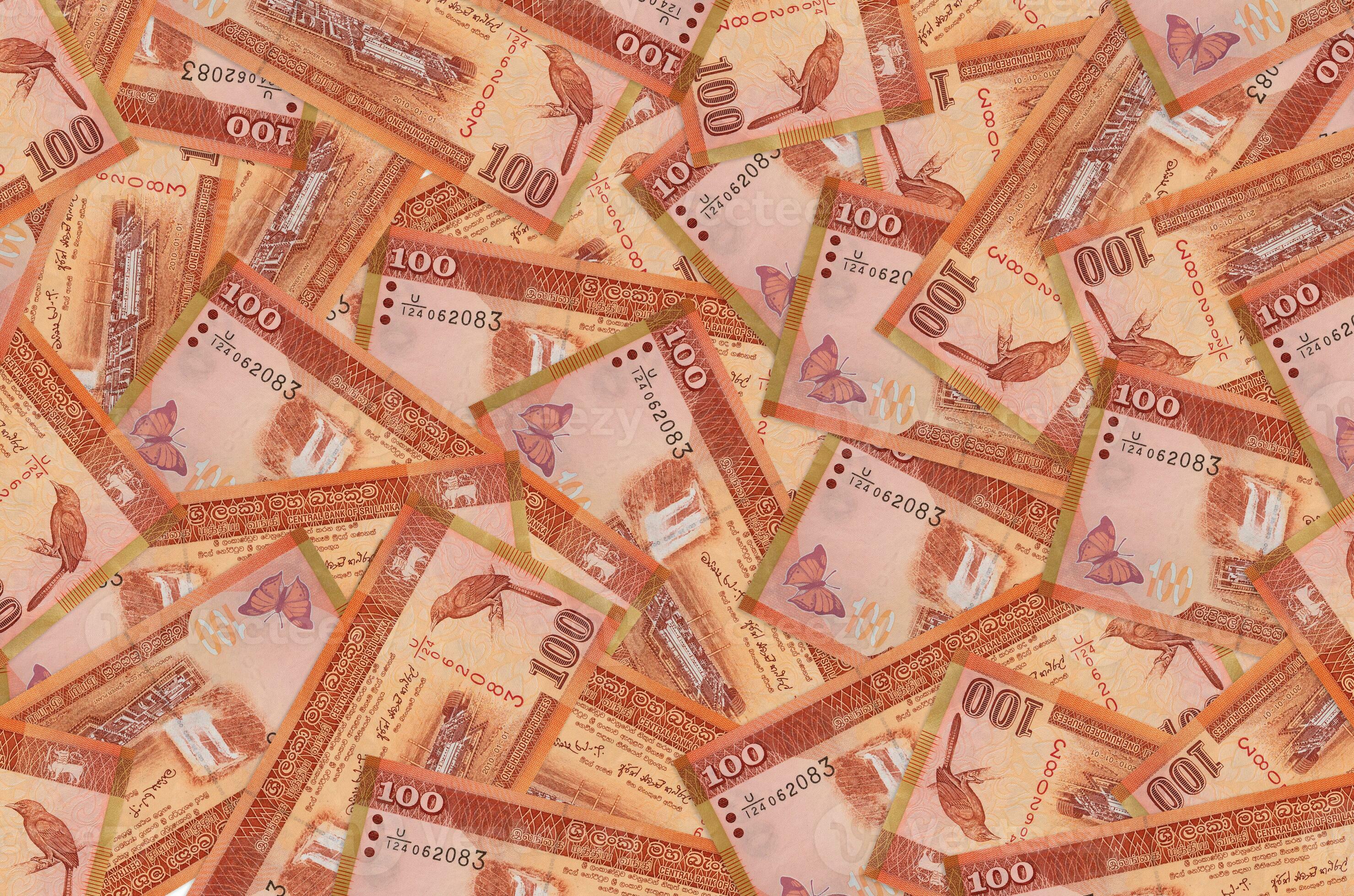 100 Sri Lankan Rupees Bills Lies In Big Pile Rich Life Conceptual sri-lankan-rupee-plunges-to-become-worst-performing-currency-in-the