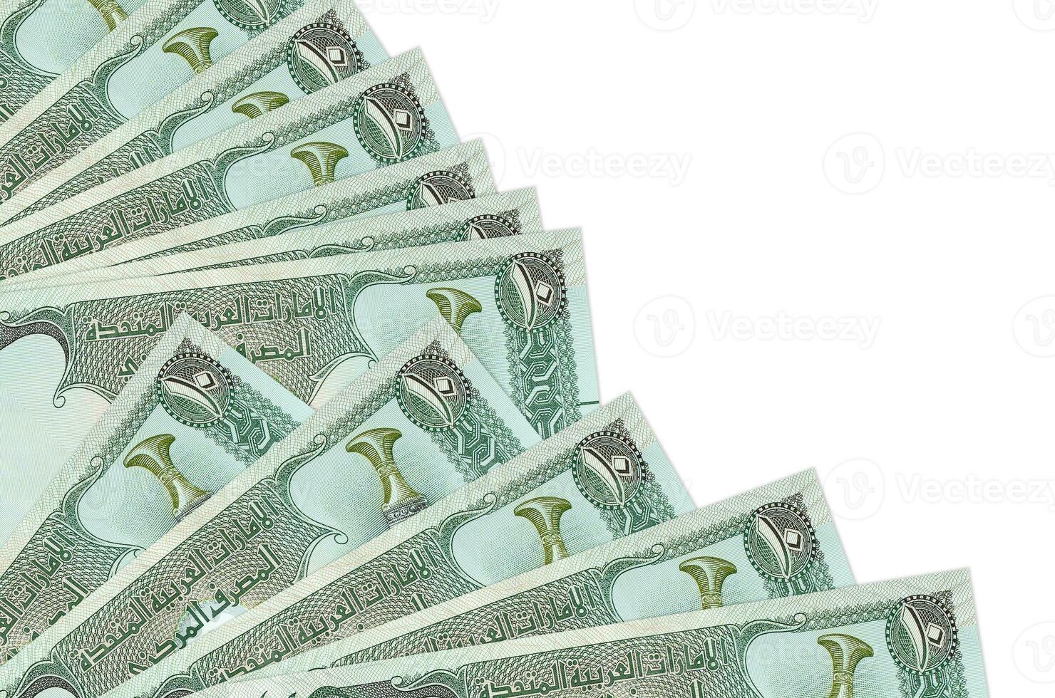 10 UAE dirhams bills lies isolated on white background with copy space stacked in fan close up photo