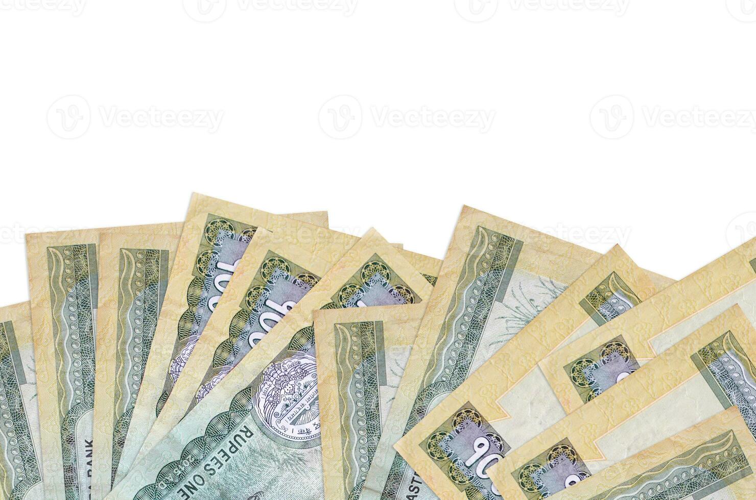 100 Nepalese rupees bills lies on bottom side of screen isolated on white background with copy space. Background banner template photo