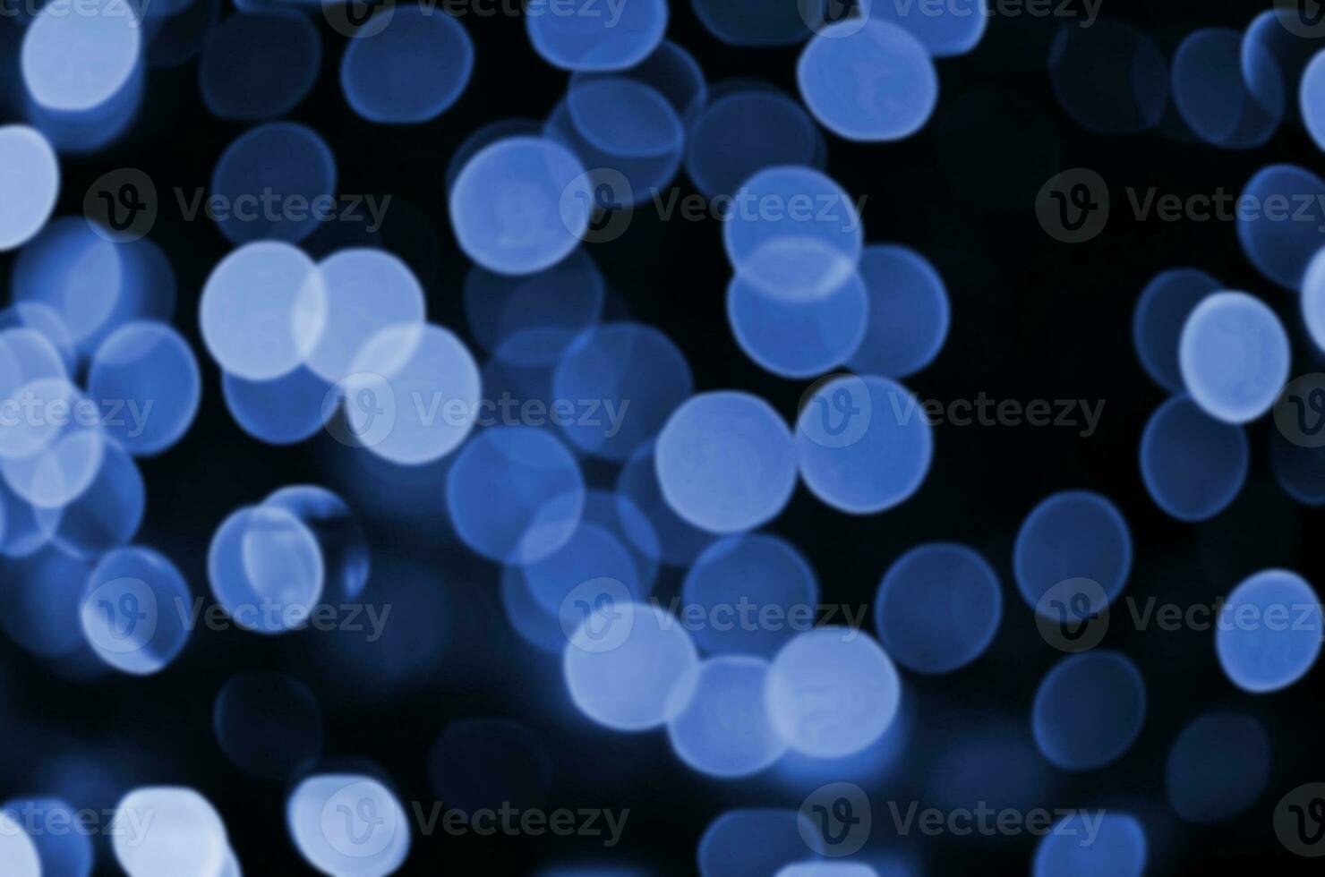 Abstract background image with bokeh effect. Many brightly colored circular shapes on a dark background. phantom classic blue color photo