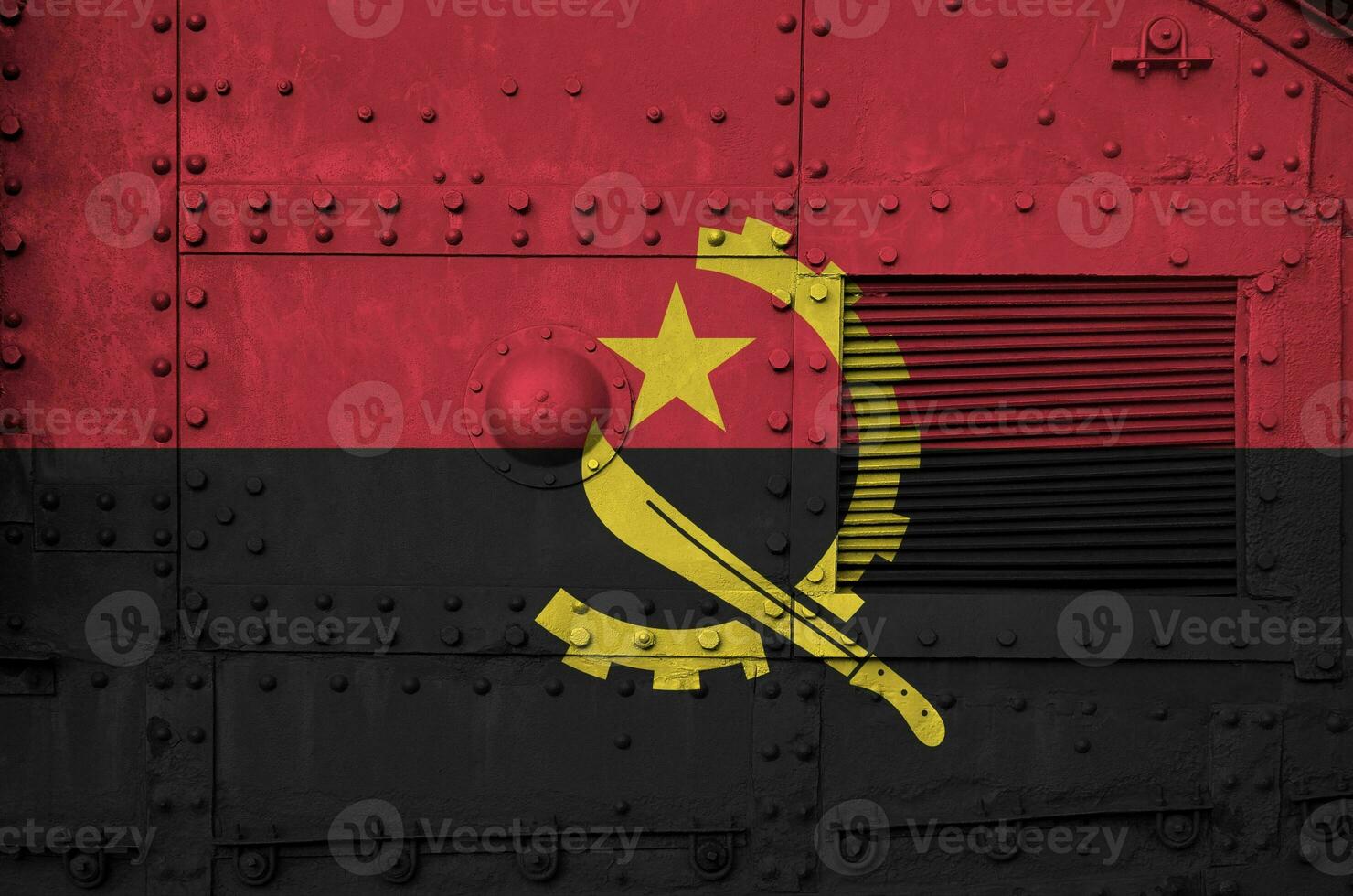 Angola flag depicted on side part of military armored tank closeup. Army forces conceptual background photo