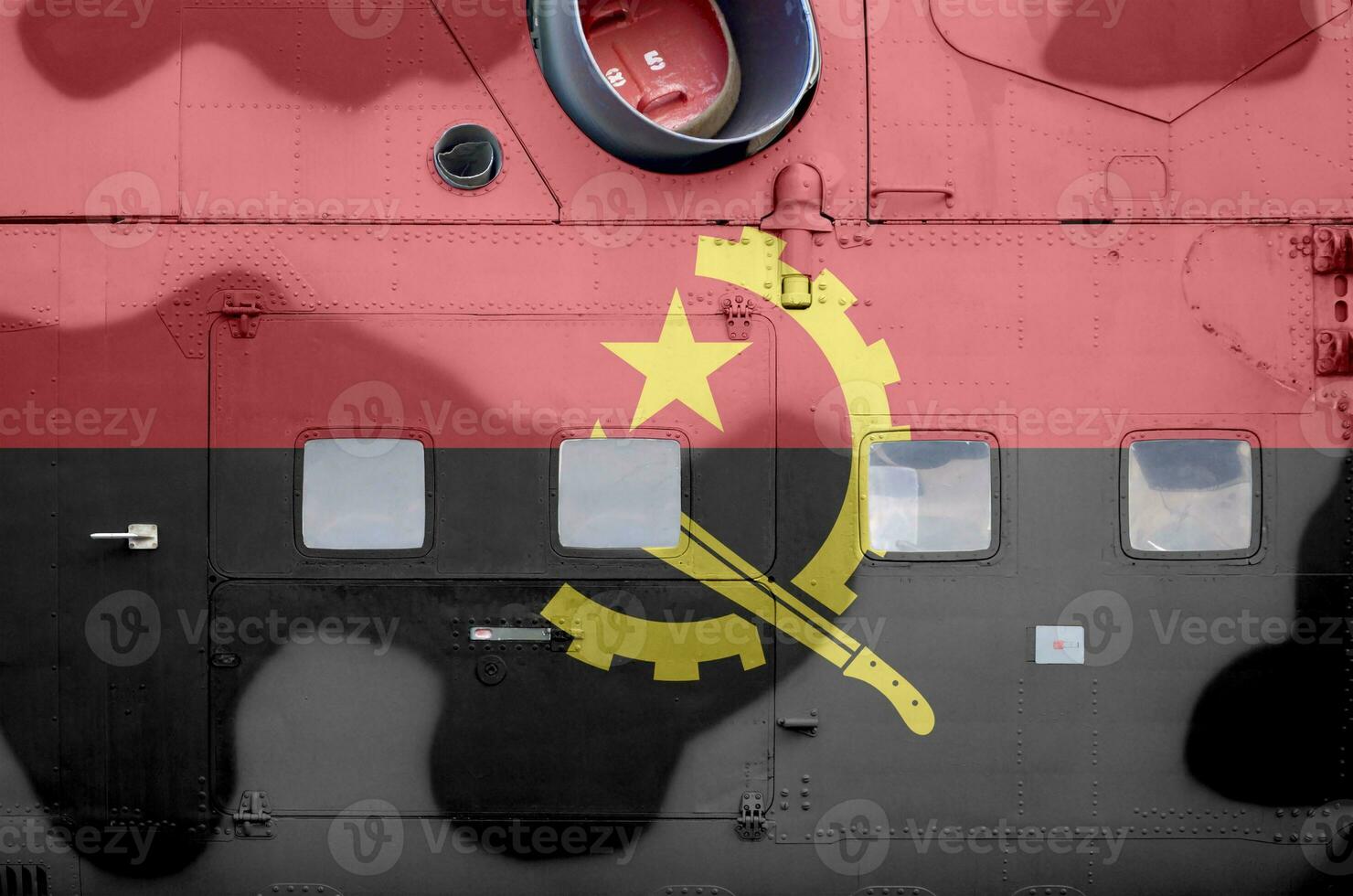 Angola flag depicted on side part of military armored helicopter closeup. Army forces aircraft conceptual background photo