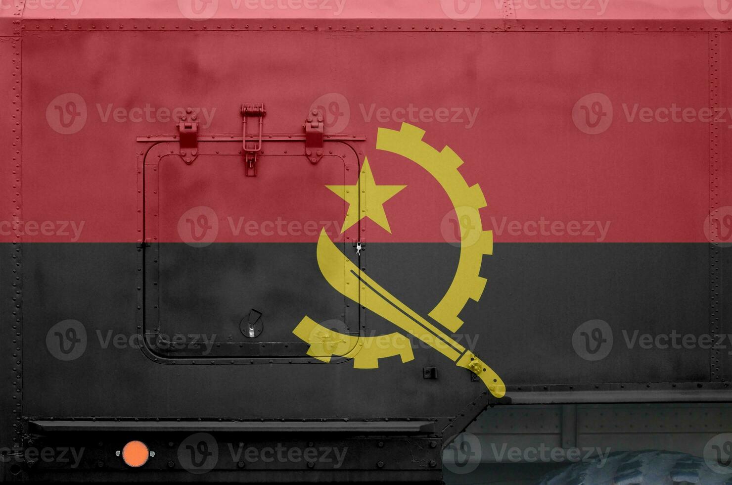 Angola flag depicted on side part of military armored truck closeup. Army forces conceptual background photo