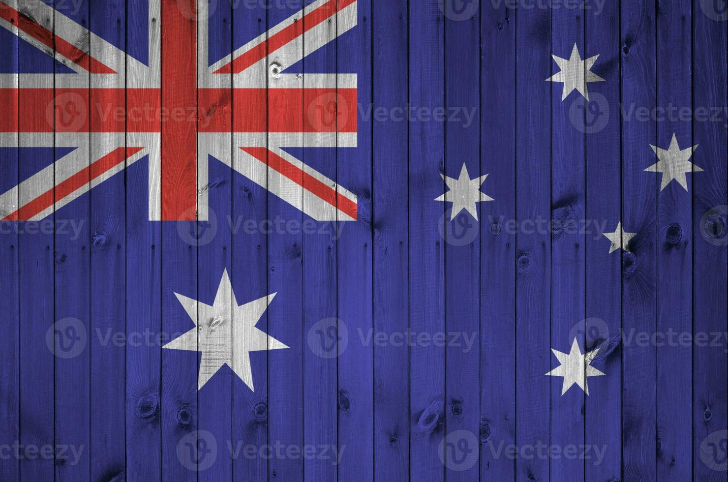 Australia flag depicted in bright paint colors on old wooden wall. Textured banner on rough background photo