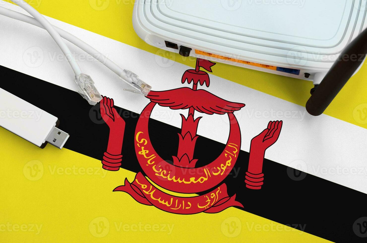 Brunei Darussalam flag depicted on table with internet rj45 cable, wireless usb wifi adapter and router. Internet connection concept photo