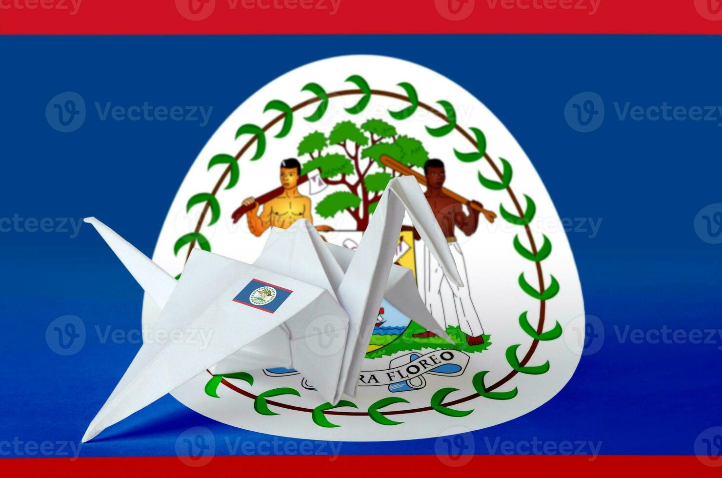 Belize flag depicted on paper origami crane wing. Handmade arts concept photo