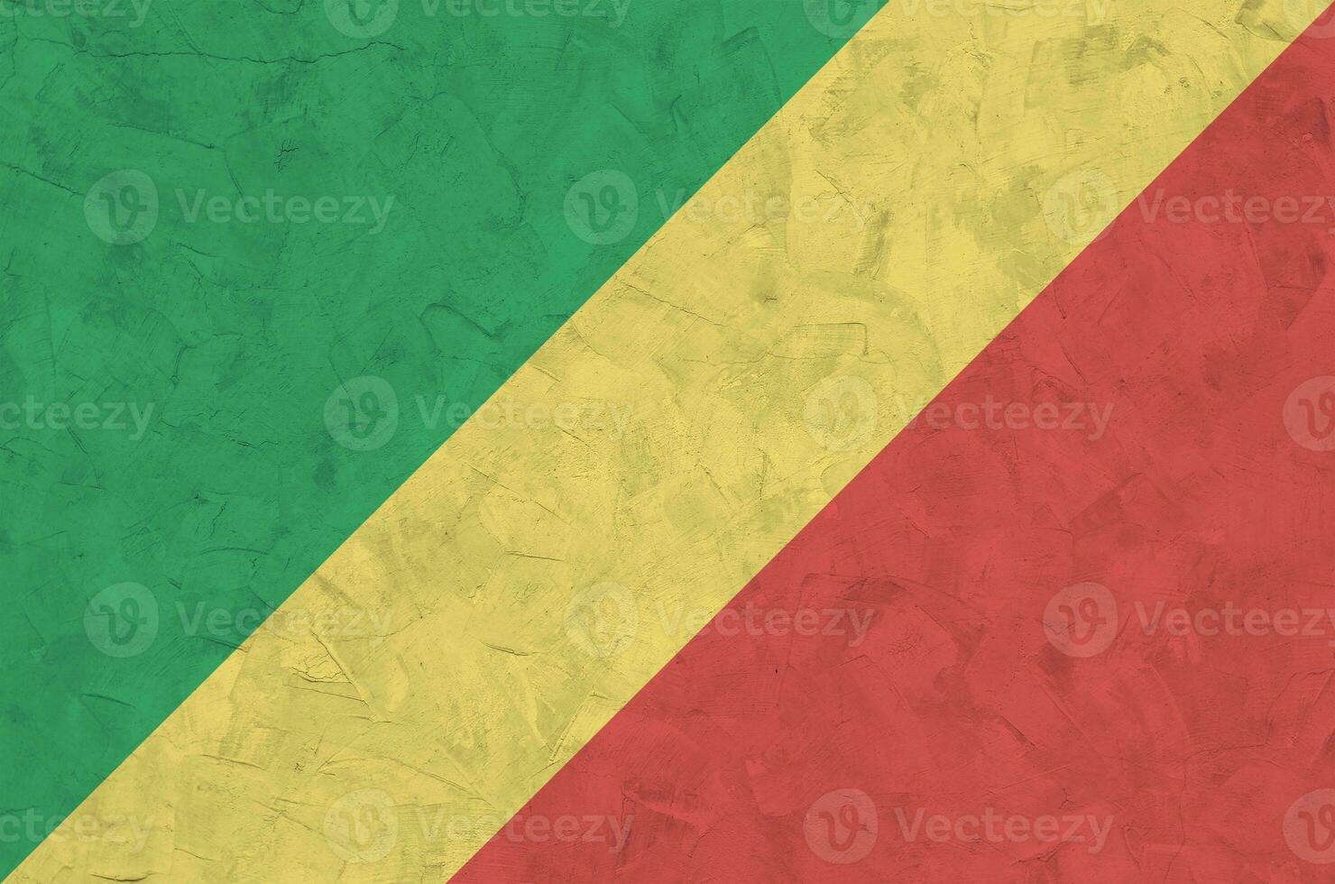 Congo flag depicted in bright paint colors on old relief plastering wall. Textured banner on rough background photo