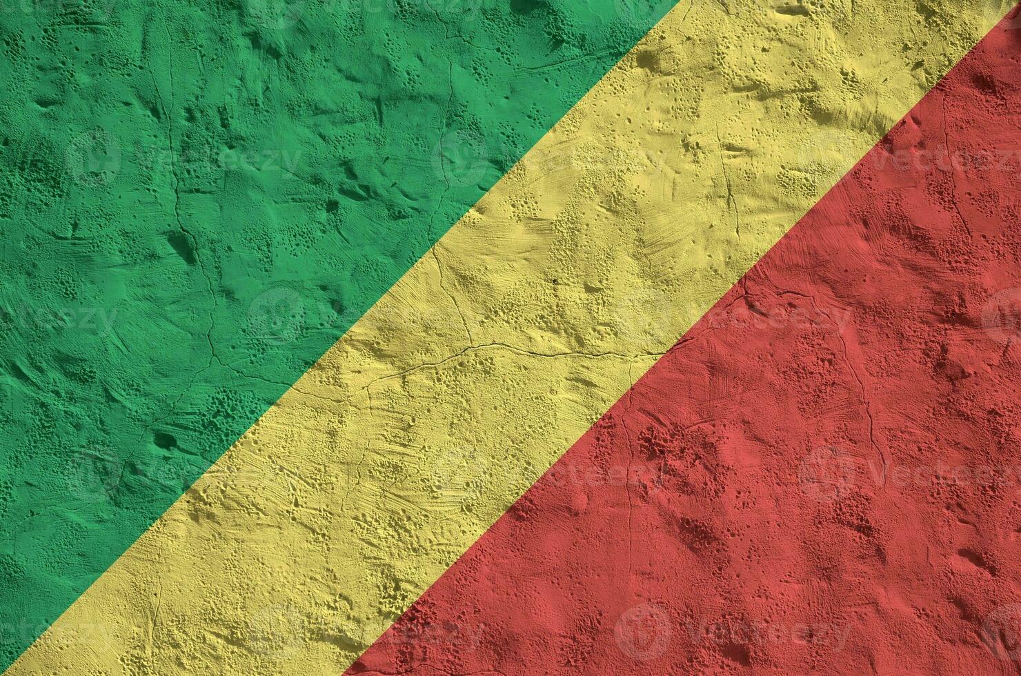 Congo flag depicted in bright paint colors on old relief plastering wall. Textured banner on rough background photo