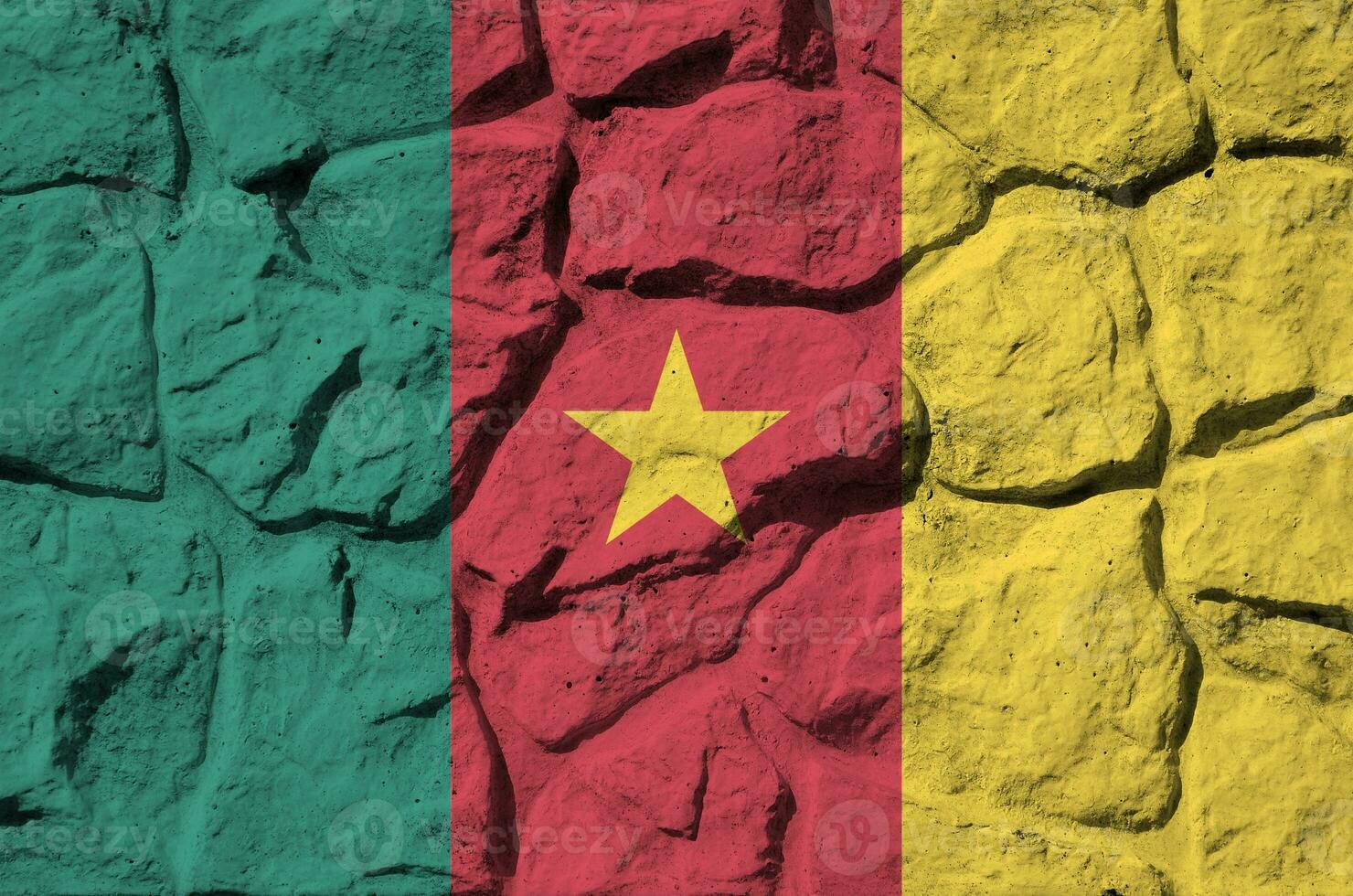 Cameroon flag depicted in paint colors on old stone wall closeup. Textured banner on rock wall background photo