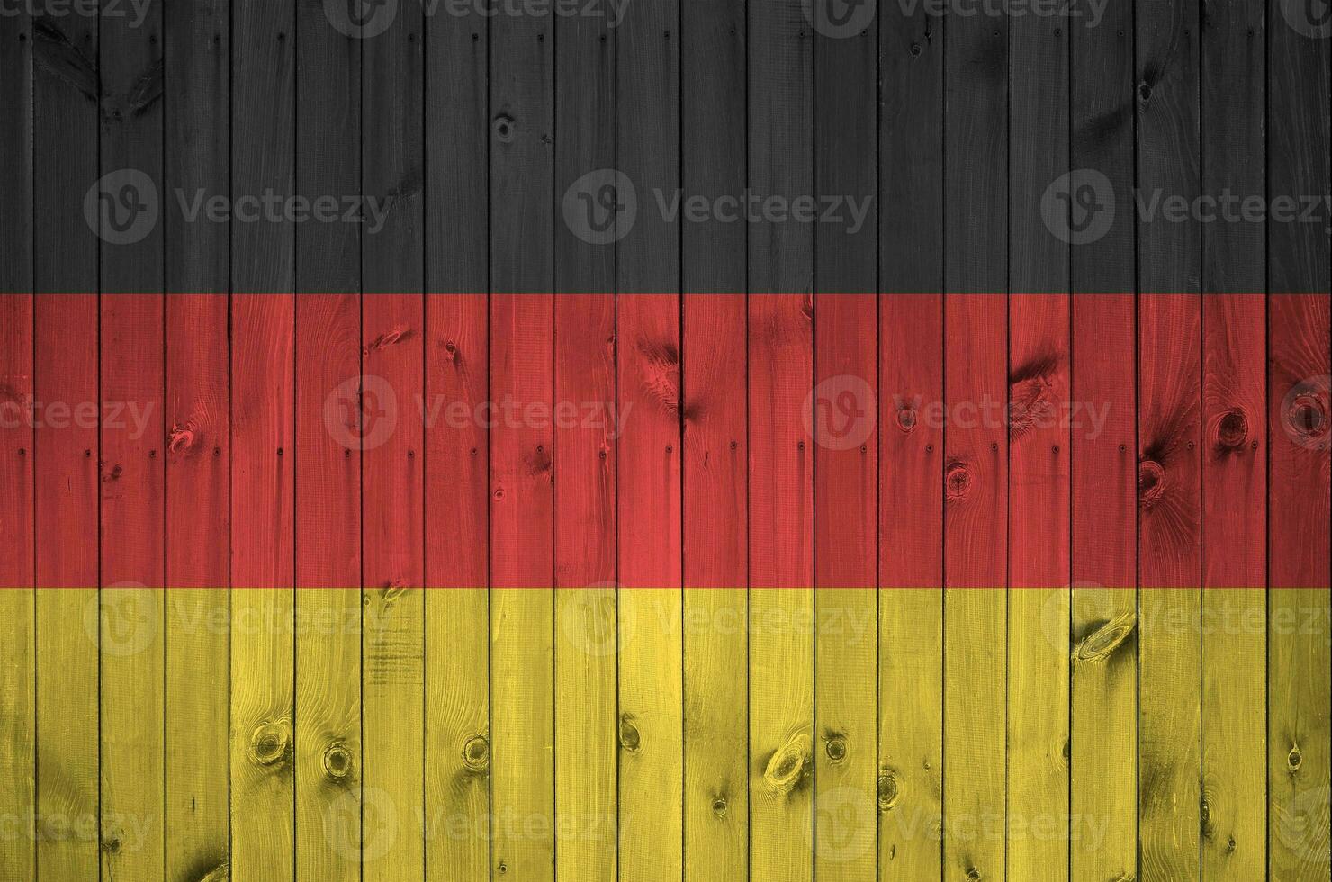 Germany flag depicted in bright paint colors on old wooden wall. Textured banner on rough background photo