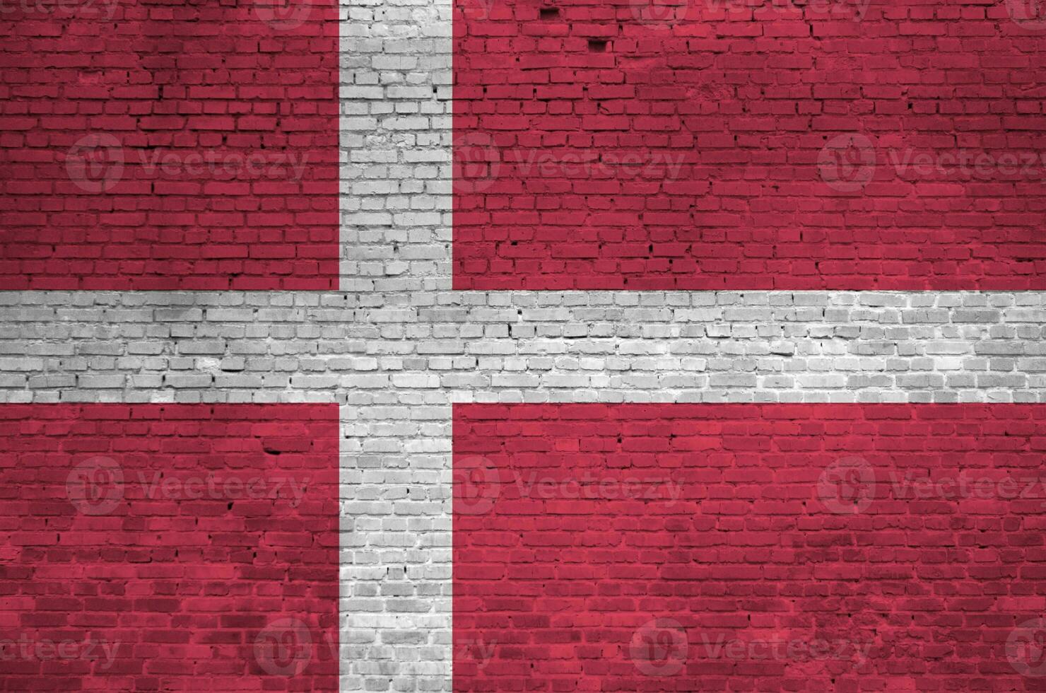 Denmark flag depicted in paint colors on old brick wall. Textured banner on big brick wall masonry background photo