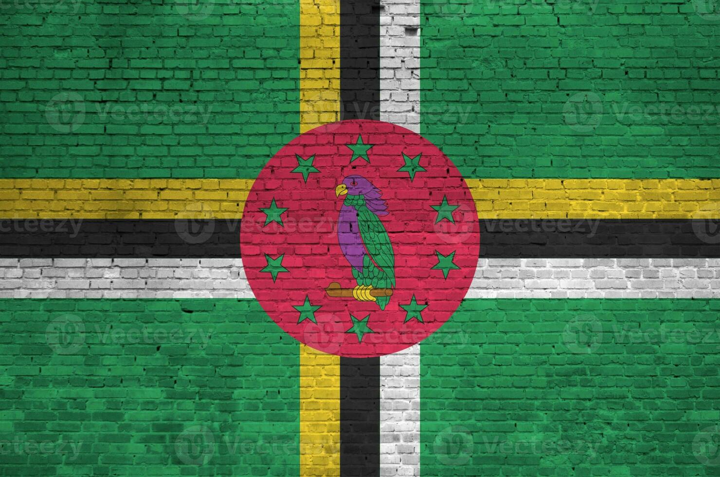 Dominica flag depicted in paint colors on old brick wall. Textured banner on big brick wall masonry background photo