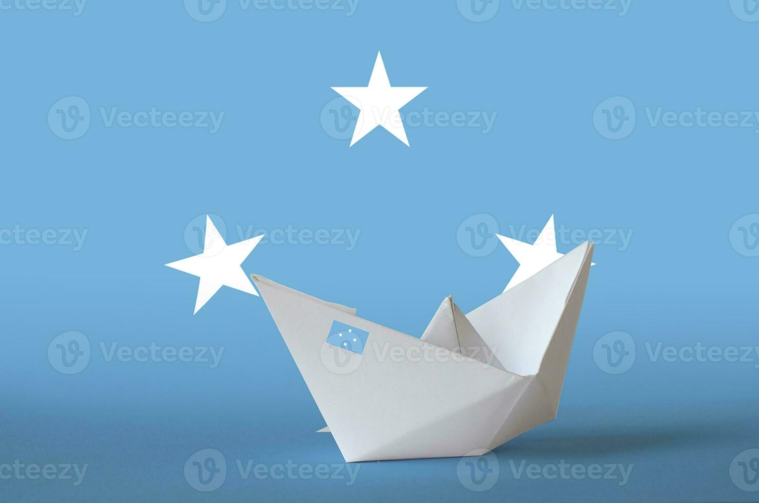 Micronesia flag depicted on paper origami ship closeup. Handmade arts concept photo