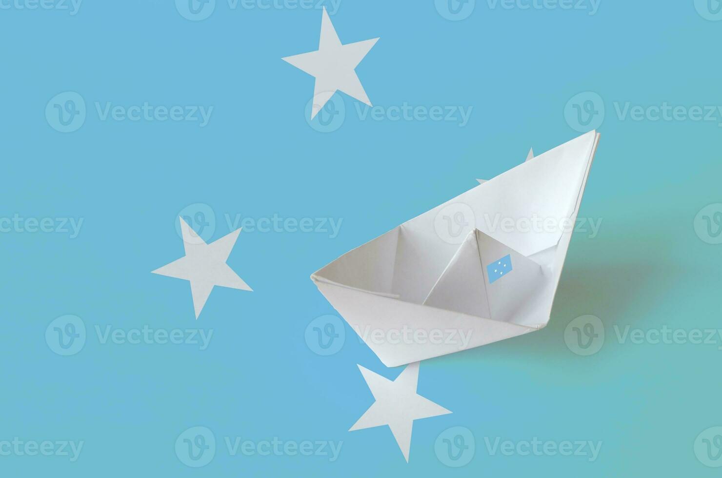 Micronesia flag depicted on paper origami ship closeup. Handmade arts concept photo