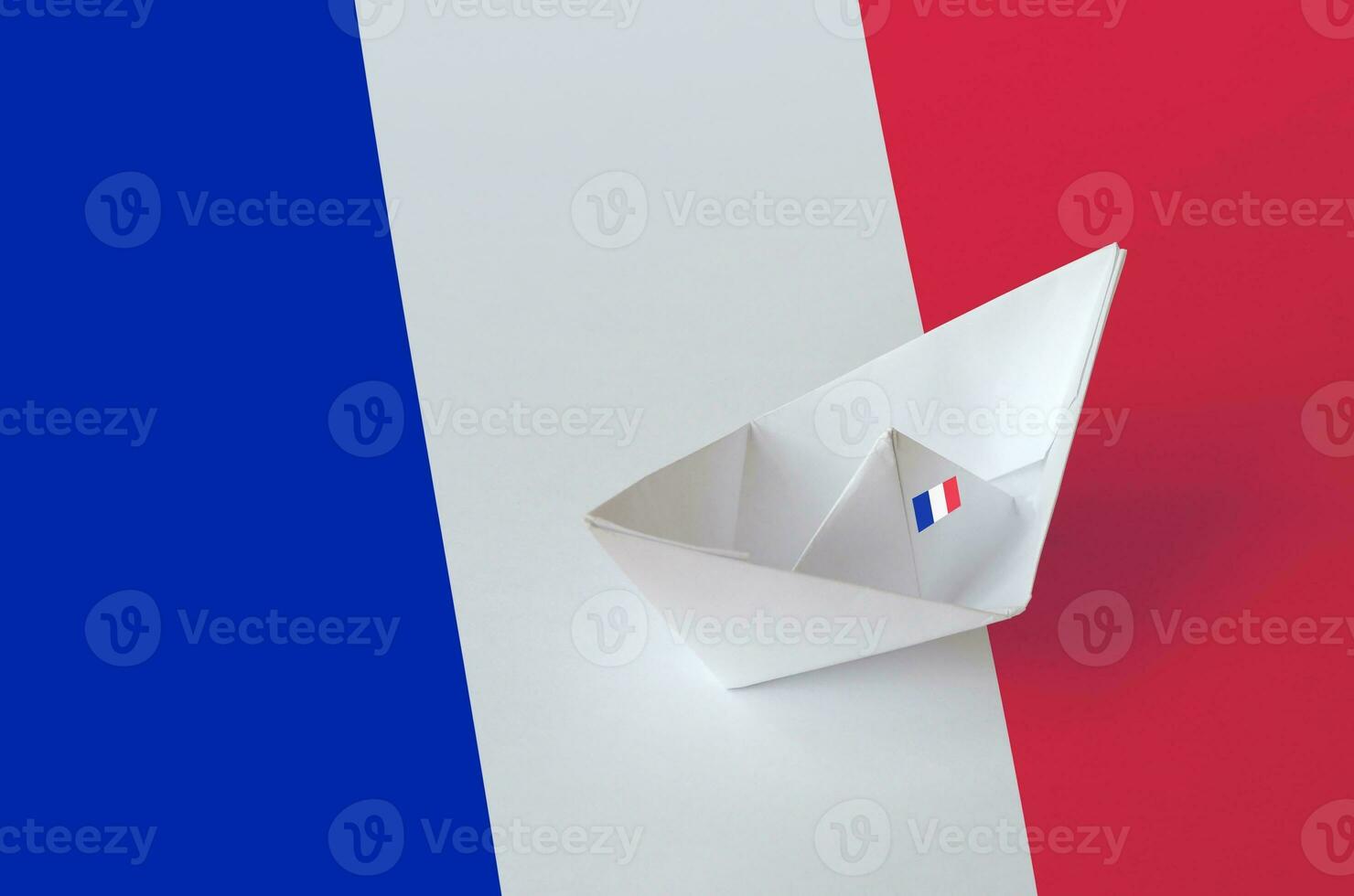 France flag depicted on paper origami ship closeup. Handmade arts concept photo