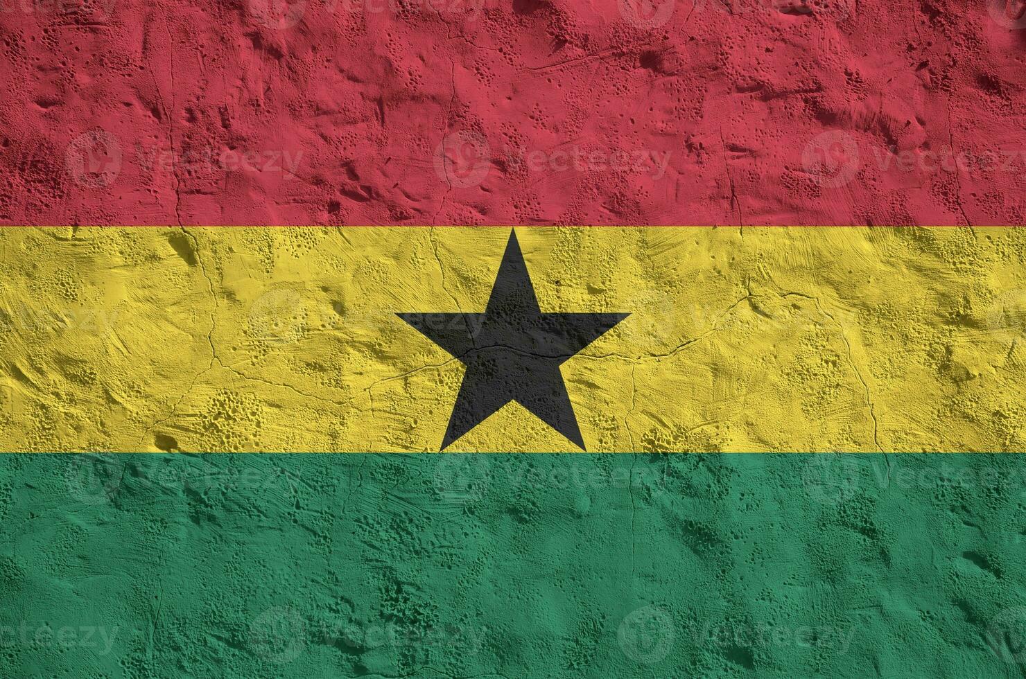 Ghana flag depicted in bright paint colors on old relief plastering wall. Textured banner on rough background photo