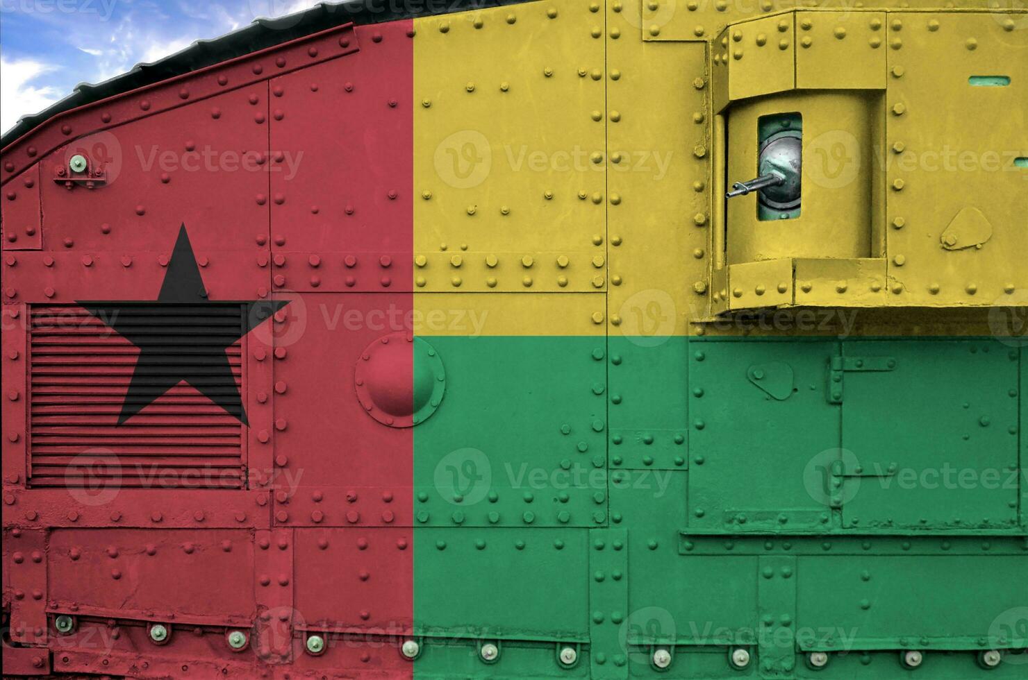 Guinea Bissau flag depicted on side part of military armored tank closeup. Army forces conceptual background photo